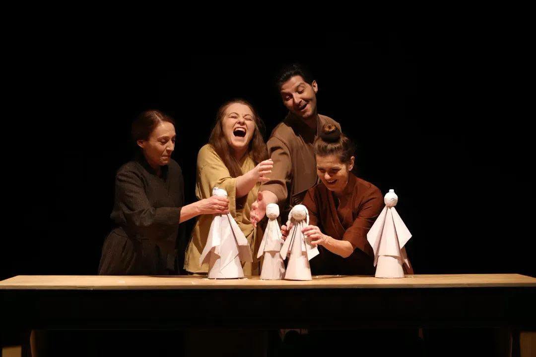 Actors laughing with puppets
