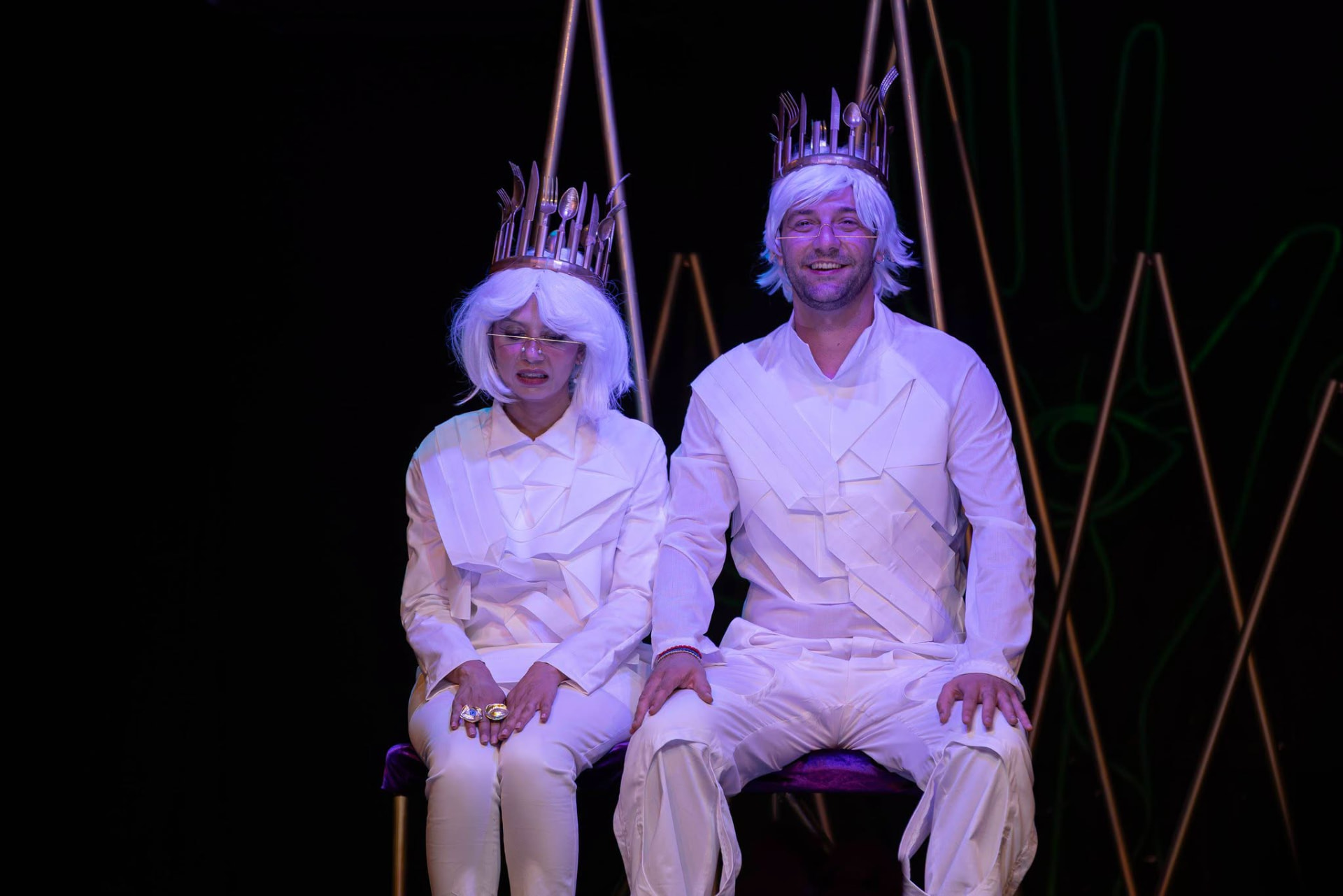 Two performers in white with crowns